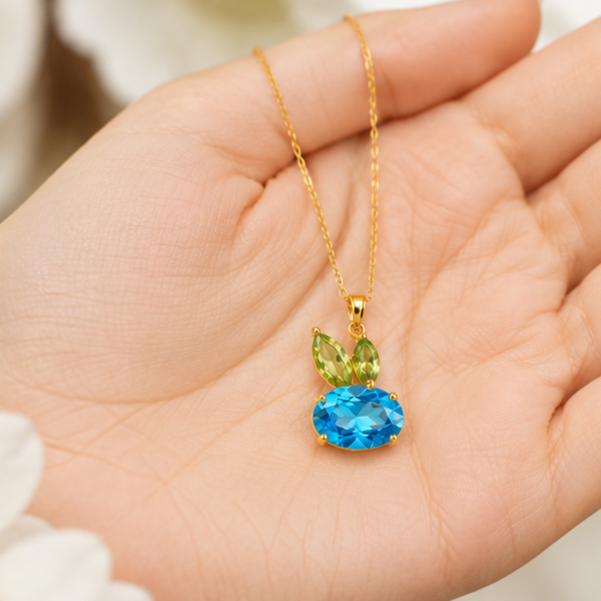 Blue crystal pendant necklace with a gold tone finish and delicate chain by Maelle