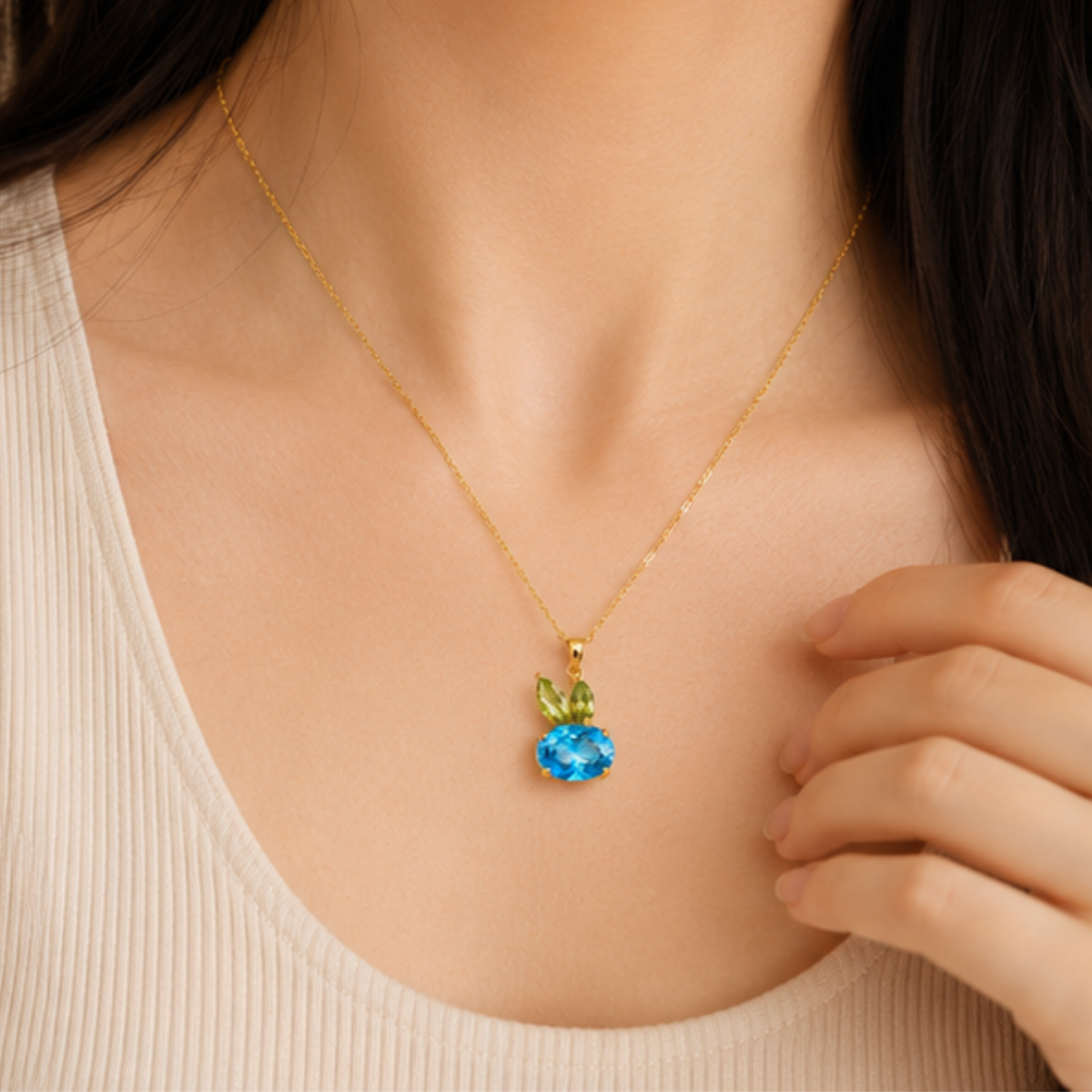 Delicate gold tone necklace featuring a blue crystal pendant for everyday wear by Maelle
