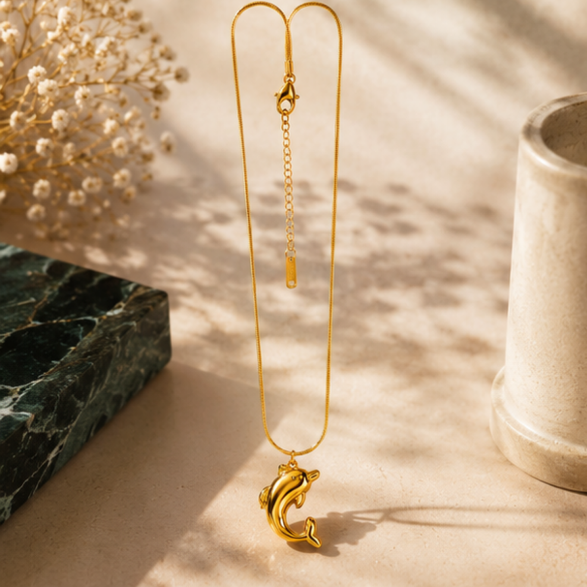 Delicate gold tone necklace featuring a crescent-shaped pendant by Maelle