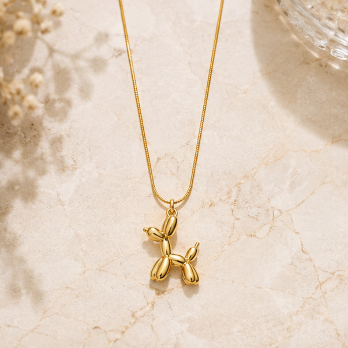 Delicate gold floral necklace with a detailed pendant and fine chain by Maelle