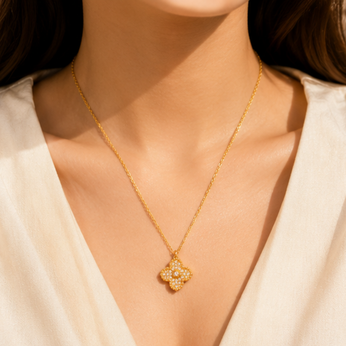 Delicate gold tone necklace featuring a detailed floral pendant by Maelle