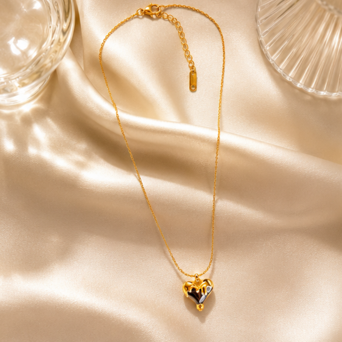 Delicate gold tone necklace featuring a heart-shaped pendant by Maelle