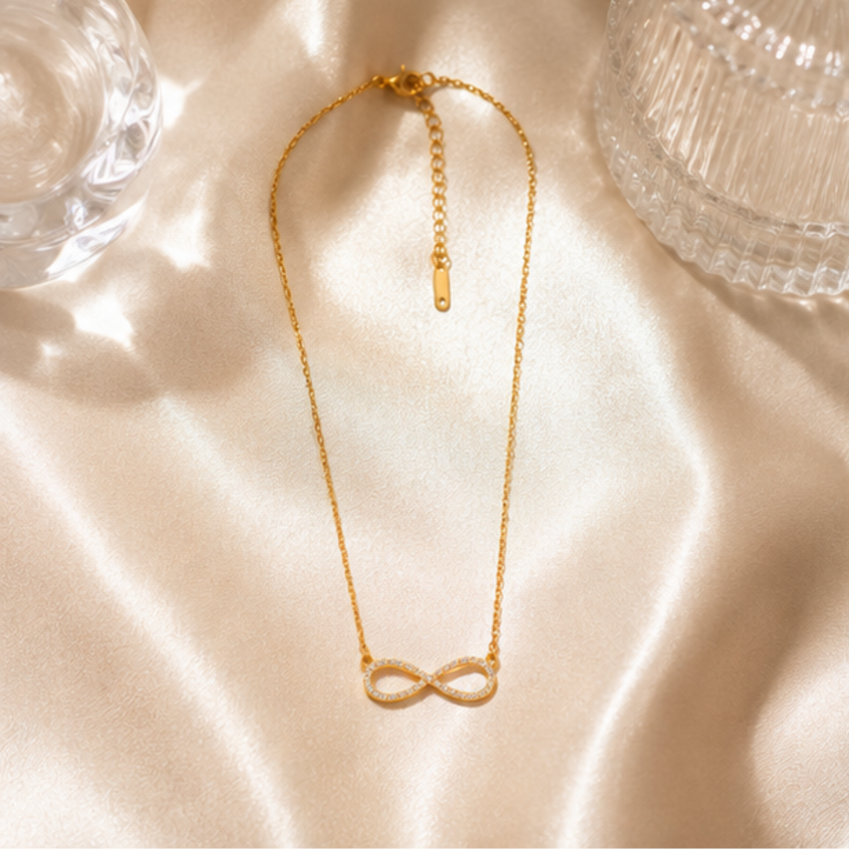 Delicate gold tone necklace featuring an infinity symbol pendant by Maelle