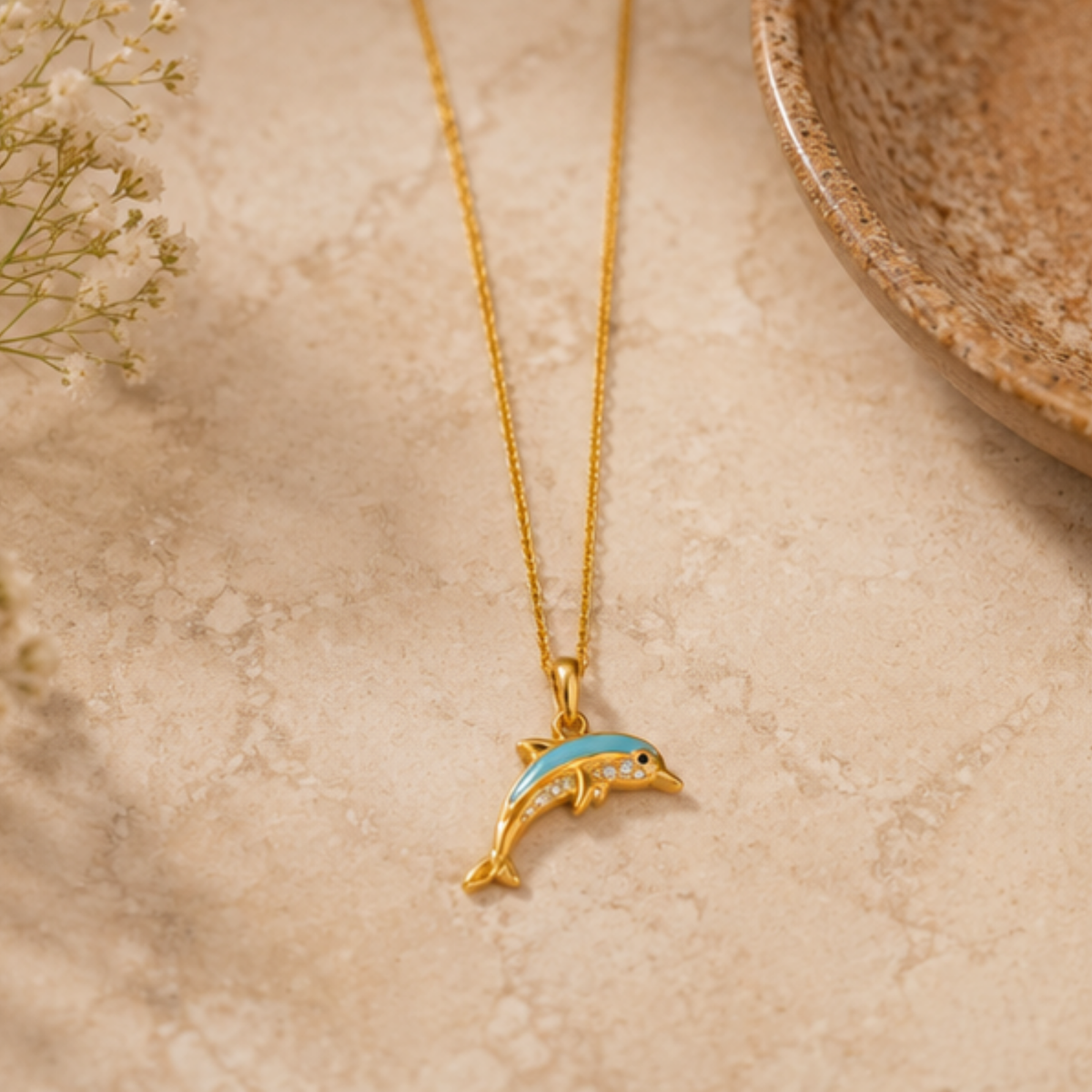 Dolphin pendant necklace for women with blue enamel detailing on a gold-tone chain | Maelle