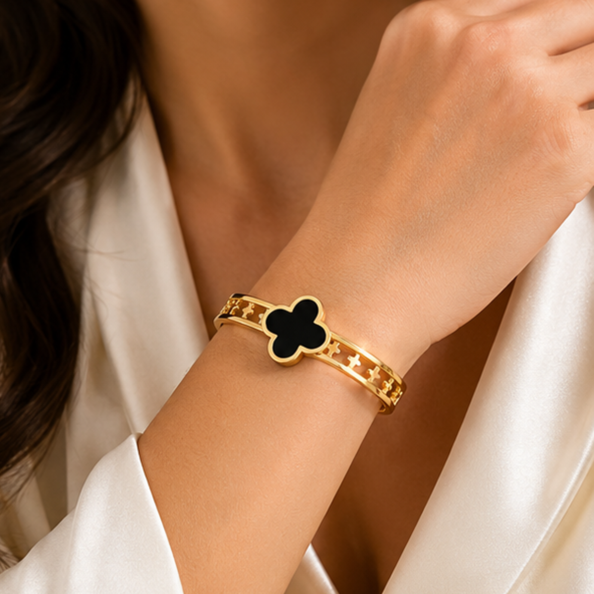 Elegant gold tone cuff bracelet with a black clover centerpiece for women by Maelle
