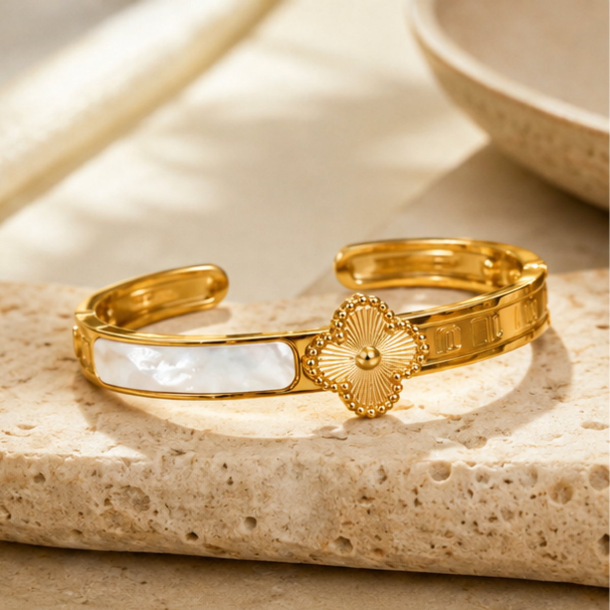 Elegant gold tone open cuff bracelet featuring a detailed floral design for women by Maelle
