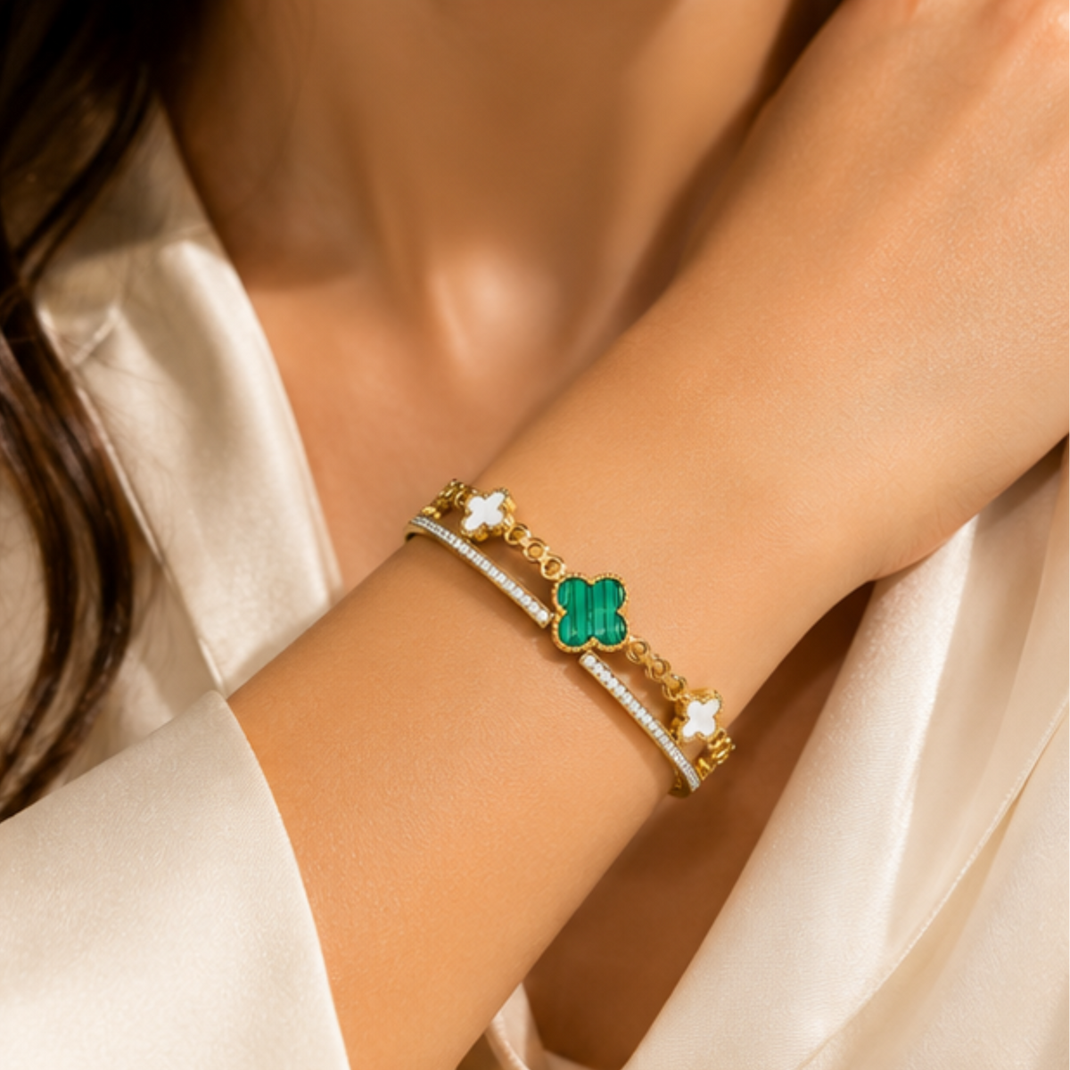 Elegant gold tone bracelet with a green clover charm designed for women by Maelle