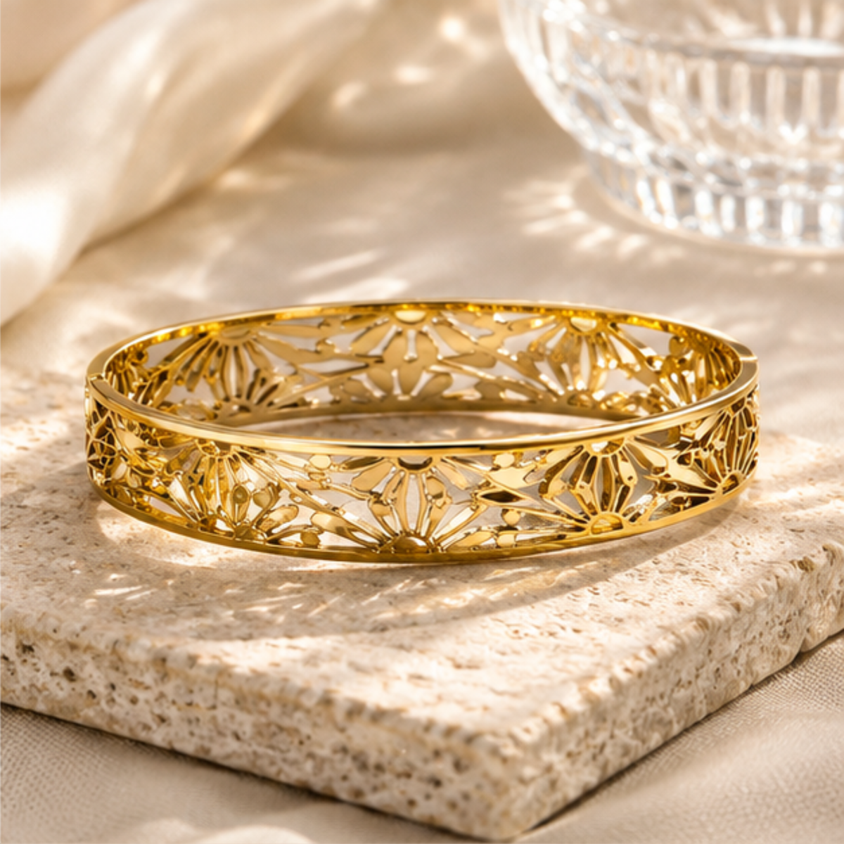 Elegant gold tone openwork bangle bracelet for women with a delicate patterned design by Maelle