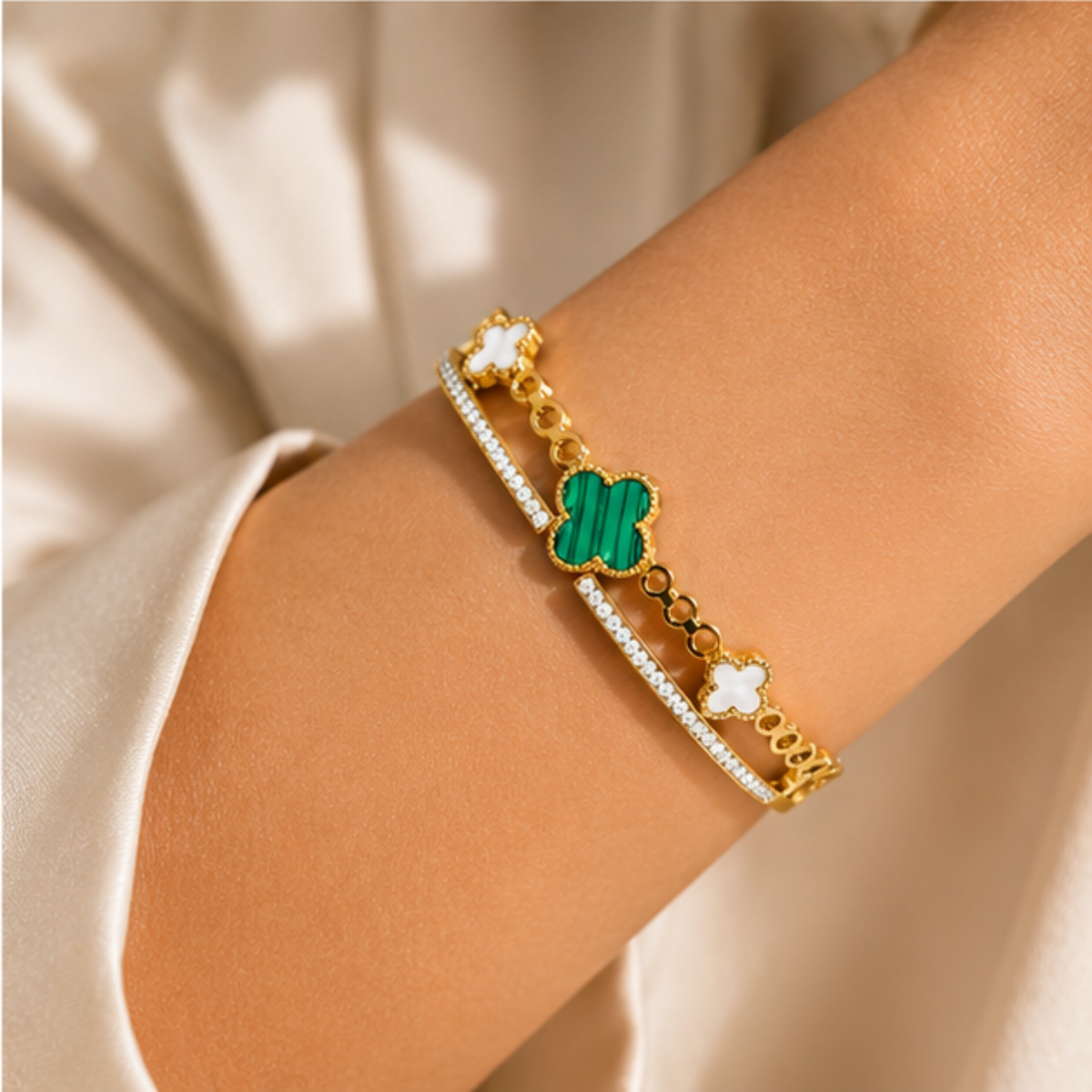 Gold tone green clover charm bracelet designed for everyday elegance and refined styling by Maelle