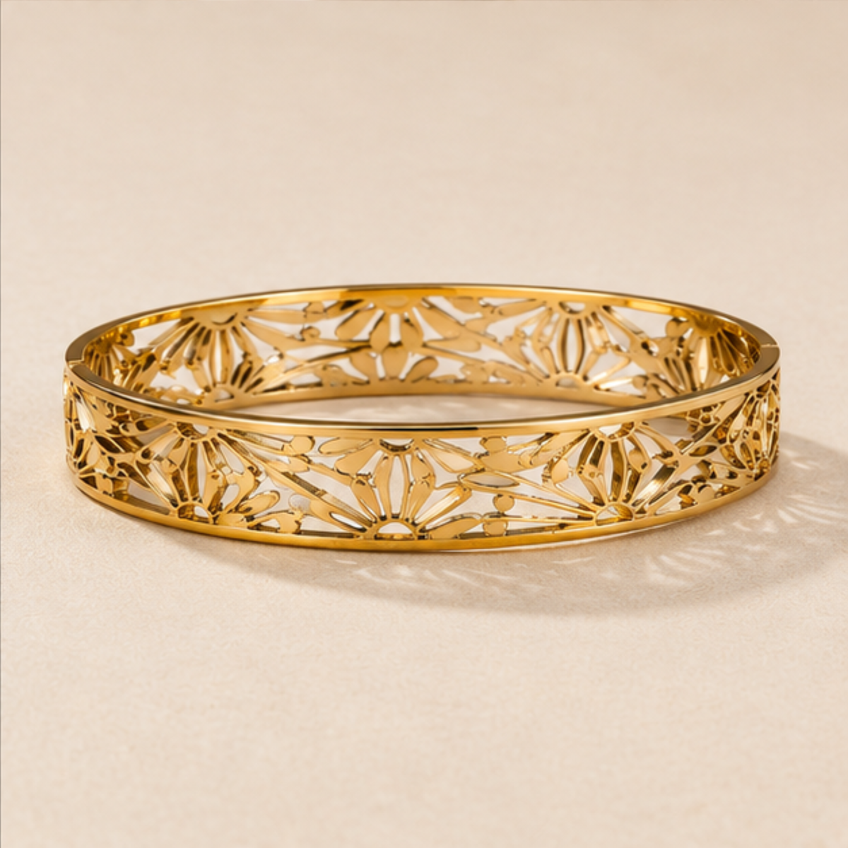 Gold tone openwork bangle bracelet designed for everyday elegance and sophisticated styling by Maelle
