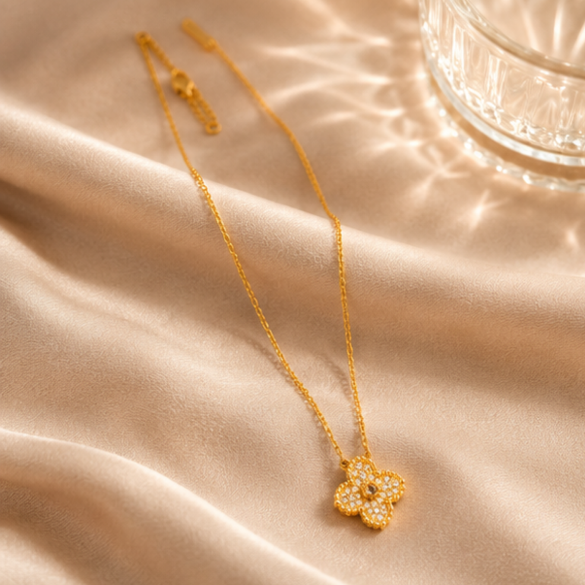 Minimal gold tone flower pendant necklace with a fine chain designed for everyday wear by Maelle